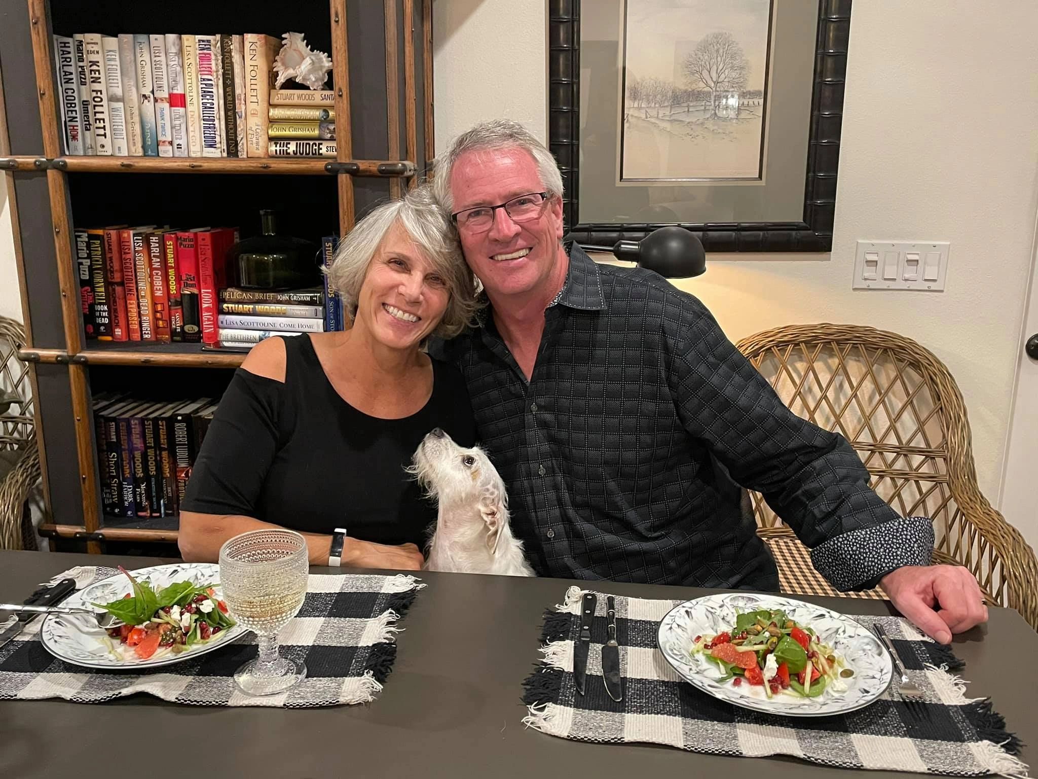 Couple dining with dog at table