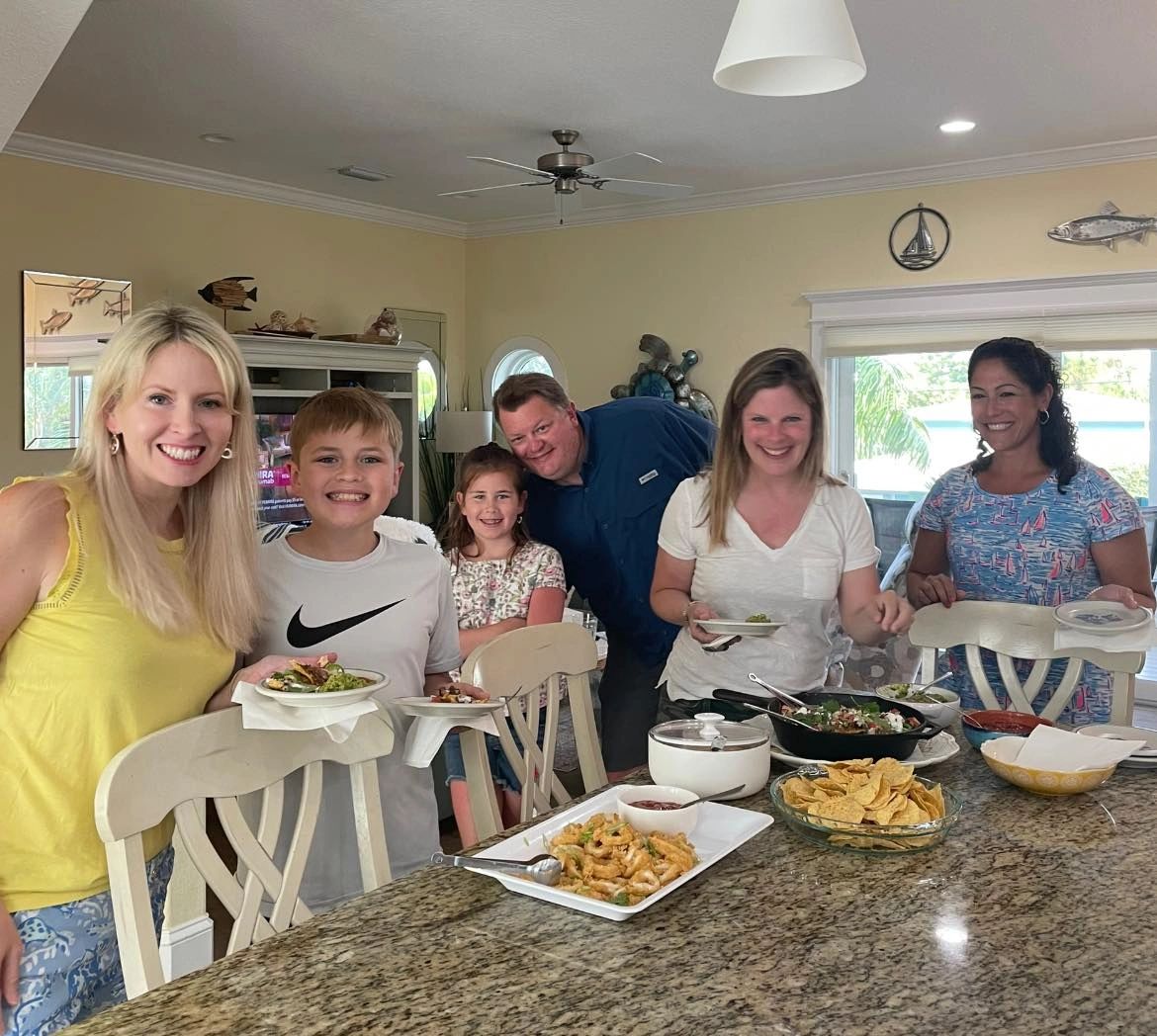 Friends gathered around food indoors