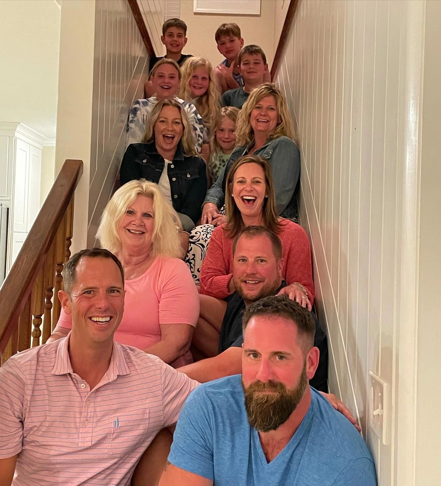 Family smiling on staircase