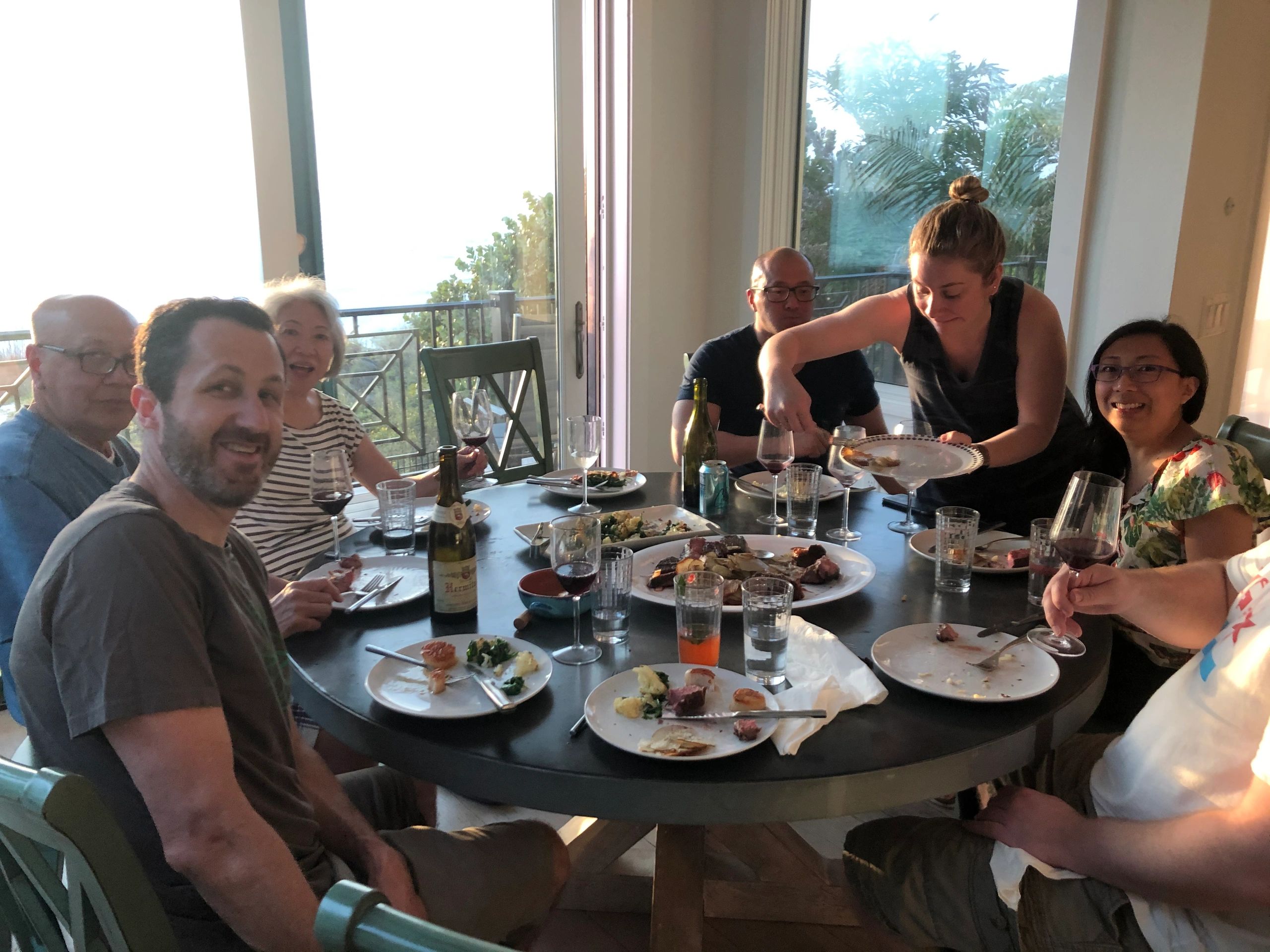 People dining with wine and laughter.